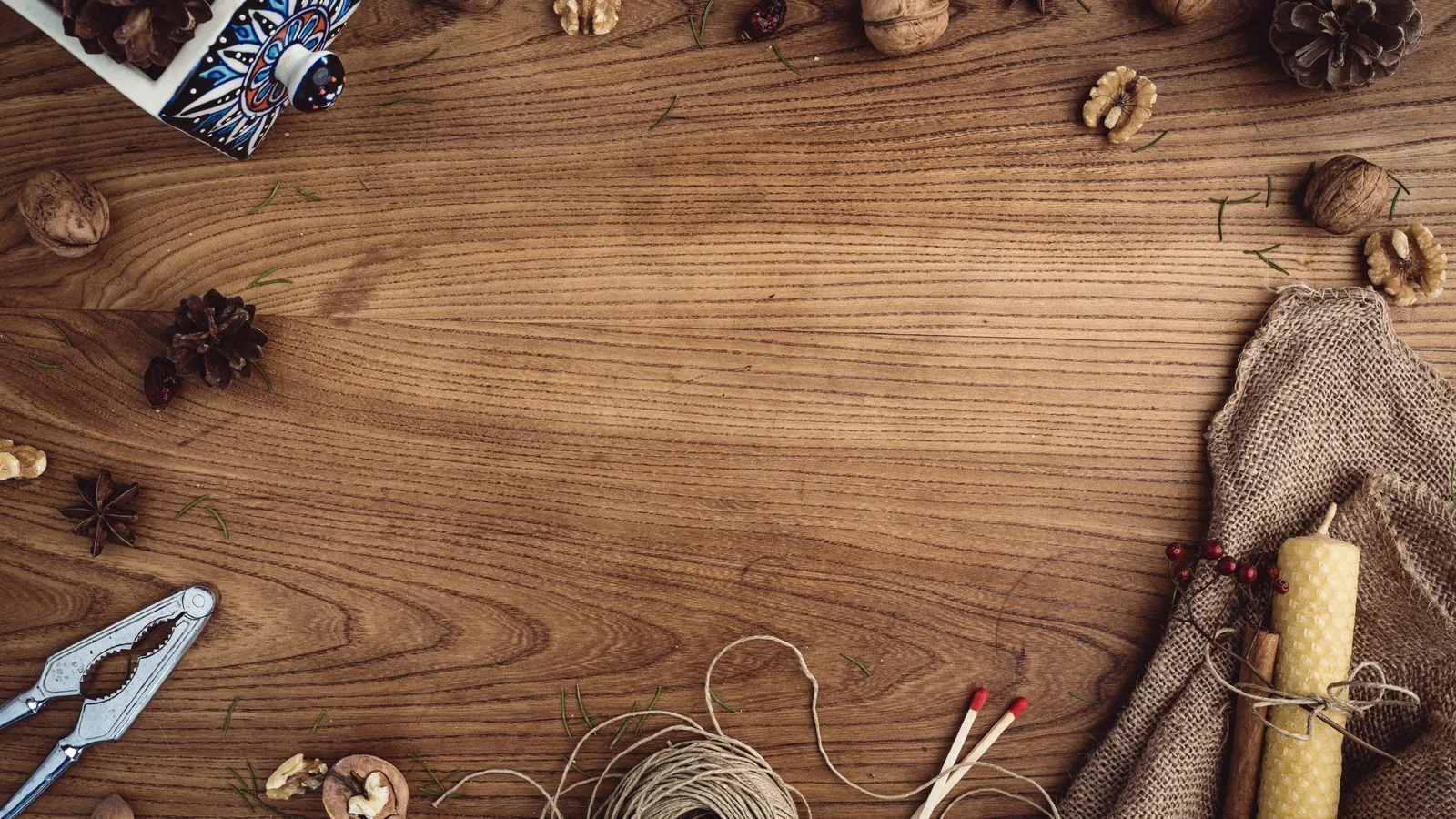 Flat lay of rustic autumn tabletop with walnuts, foliage, and decorations.