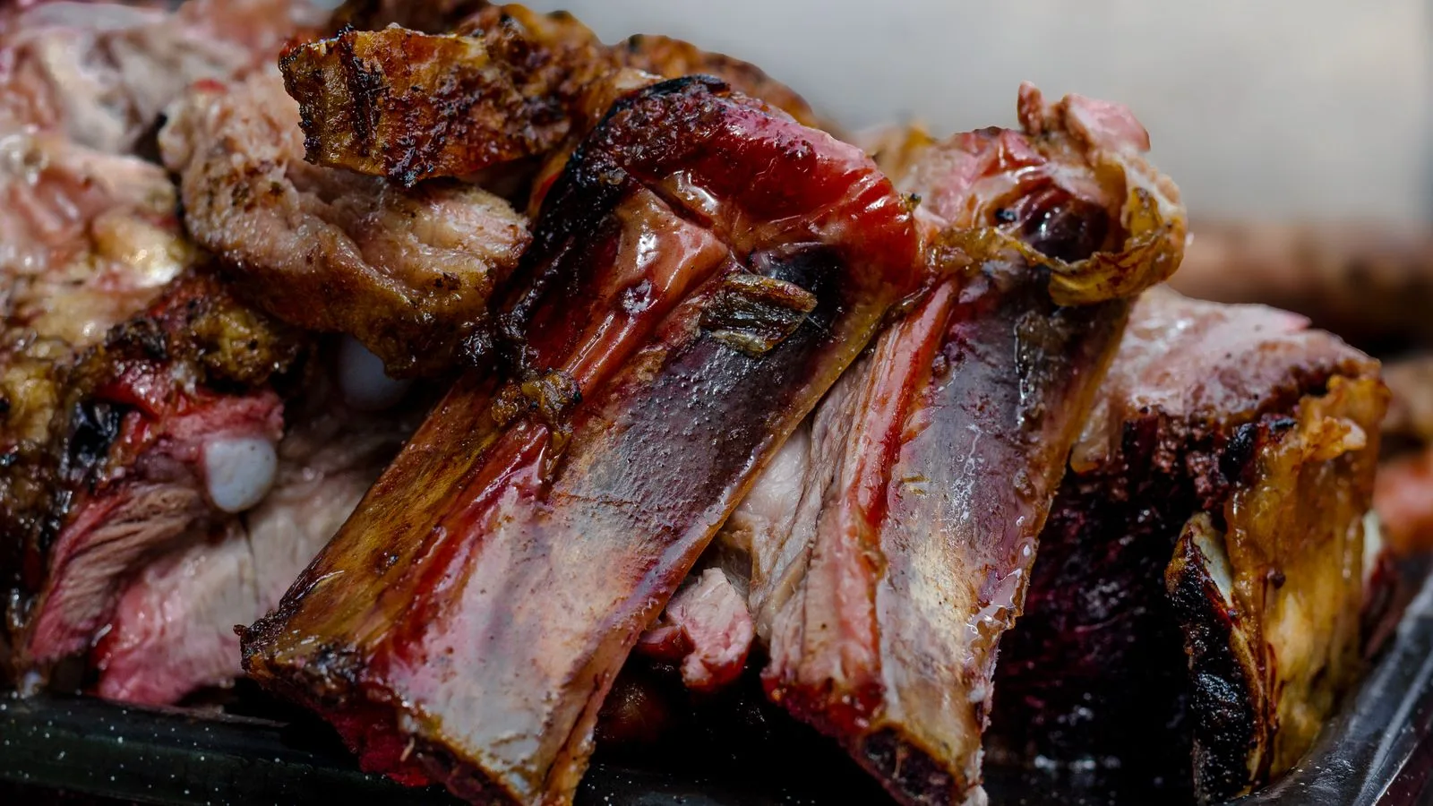 Close-up of delicious grilled ribs showcasing juicy and tender texture, typical from Argentina's barbecue style.