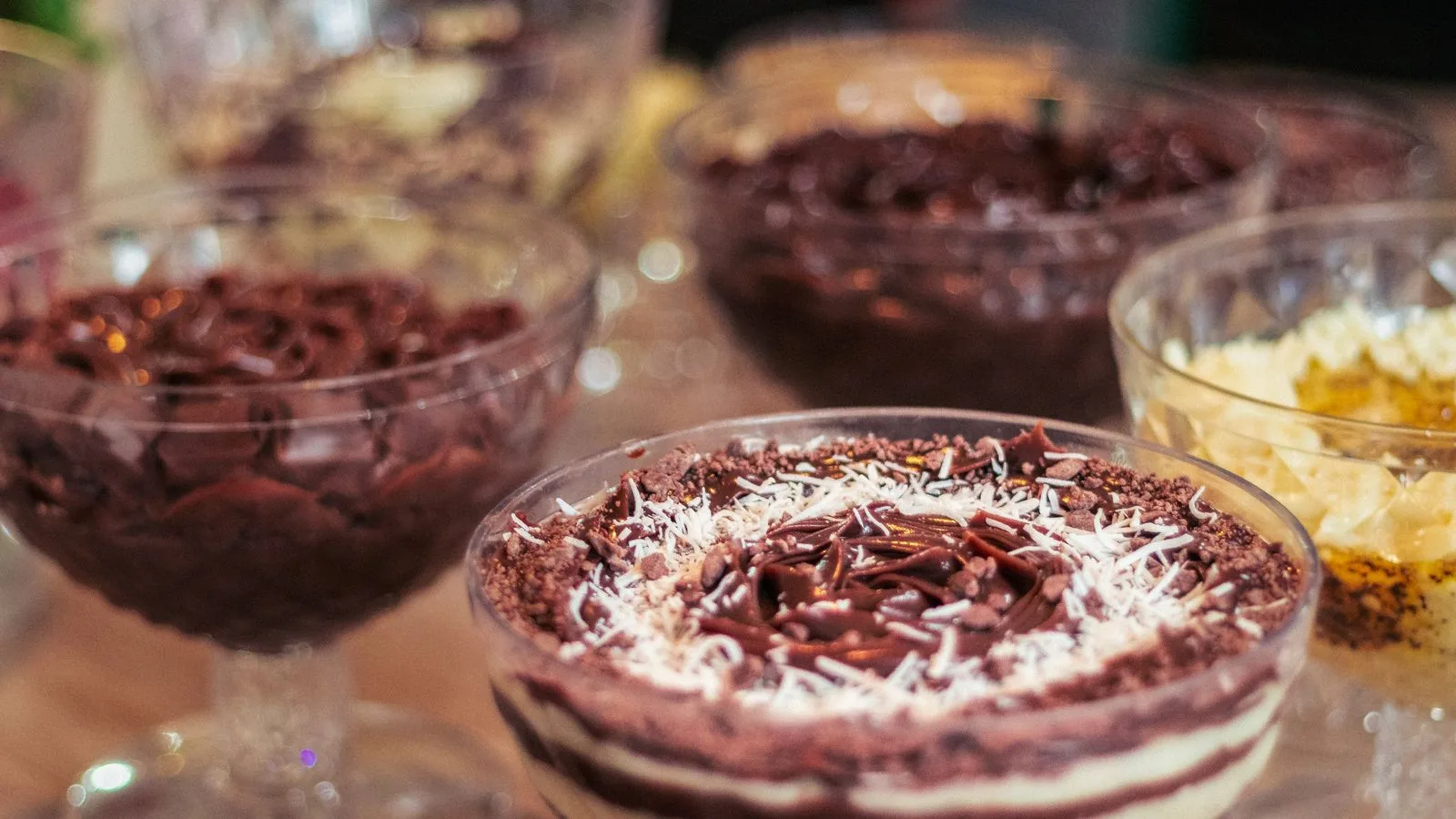 A selection of delicious Brazilian desserts, artfully presented in elegant glass bowls, perfect for indulging in sweet flavors.