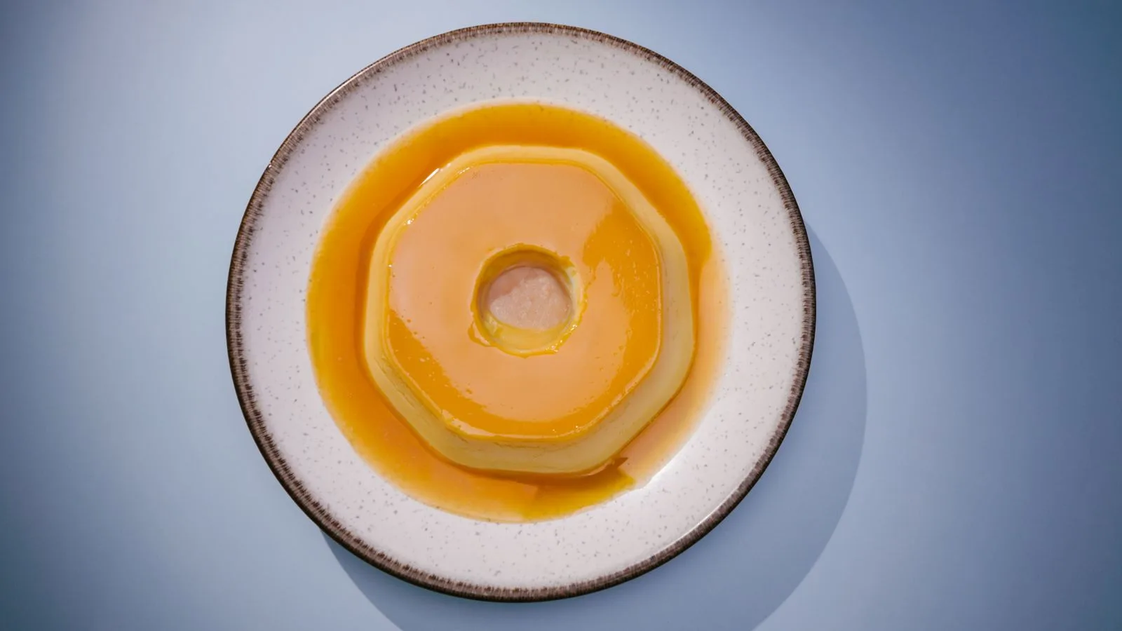 A delicious Brazilian flan on a white plate, perfect for food photography and culinary websites.
