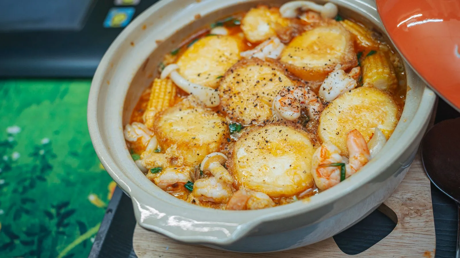 Delicious seafood and tofu hot pot packed with mushrooms, corn, and shrimp in a flavorful broth.