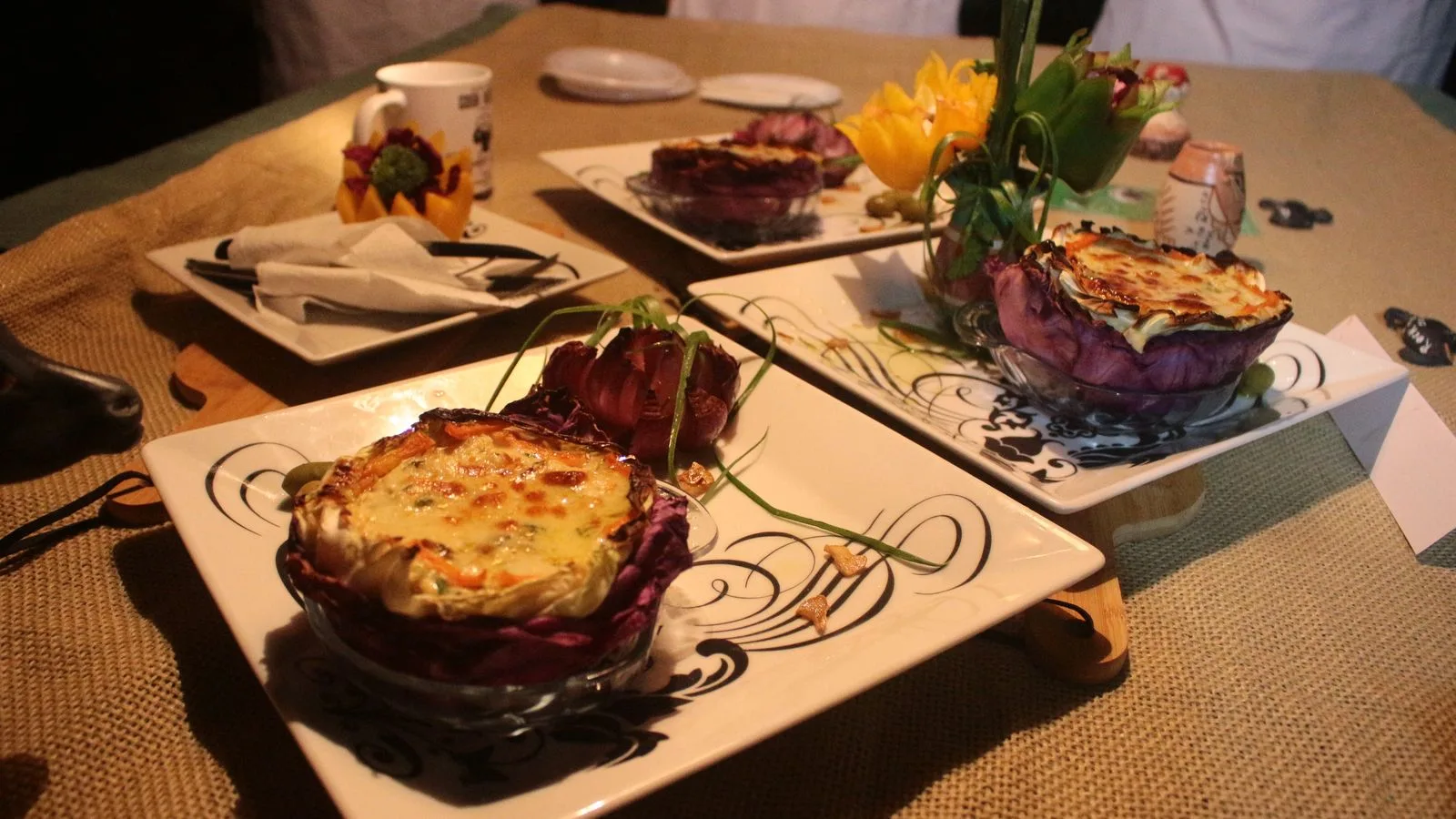 Beautifully presented gourmet dishes served at a restaurant dinner setting.