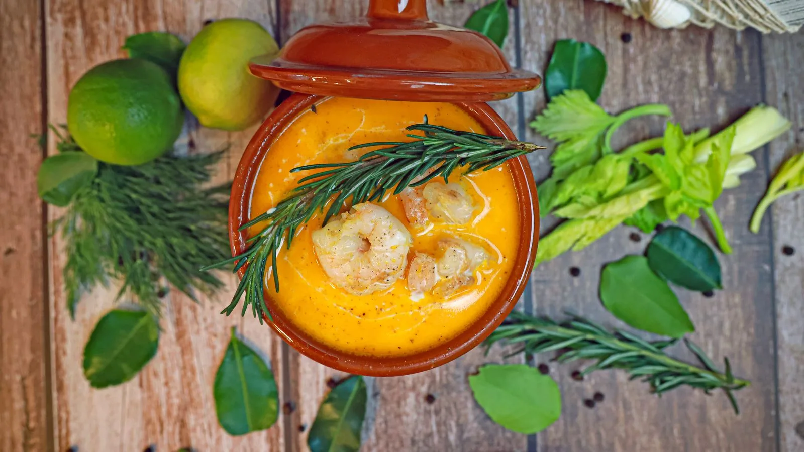 Delicious shrimp stew with herbs and spices in a rustic setting.
