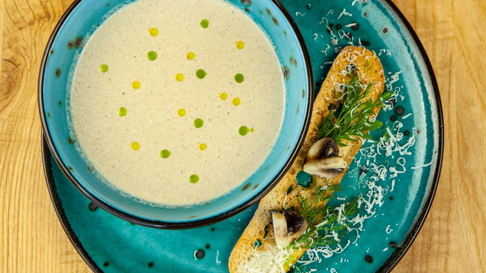 Rich mushroom soup served with a garnish-topped bread slice.