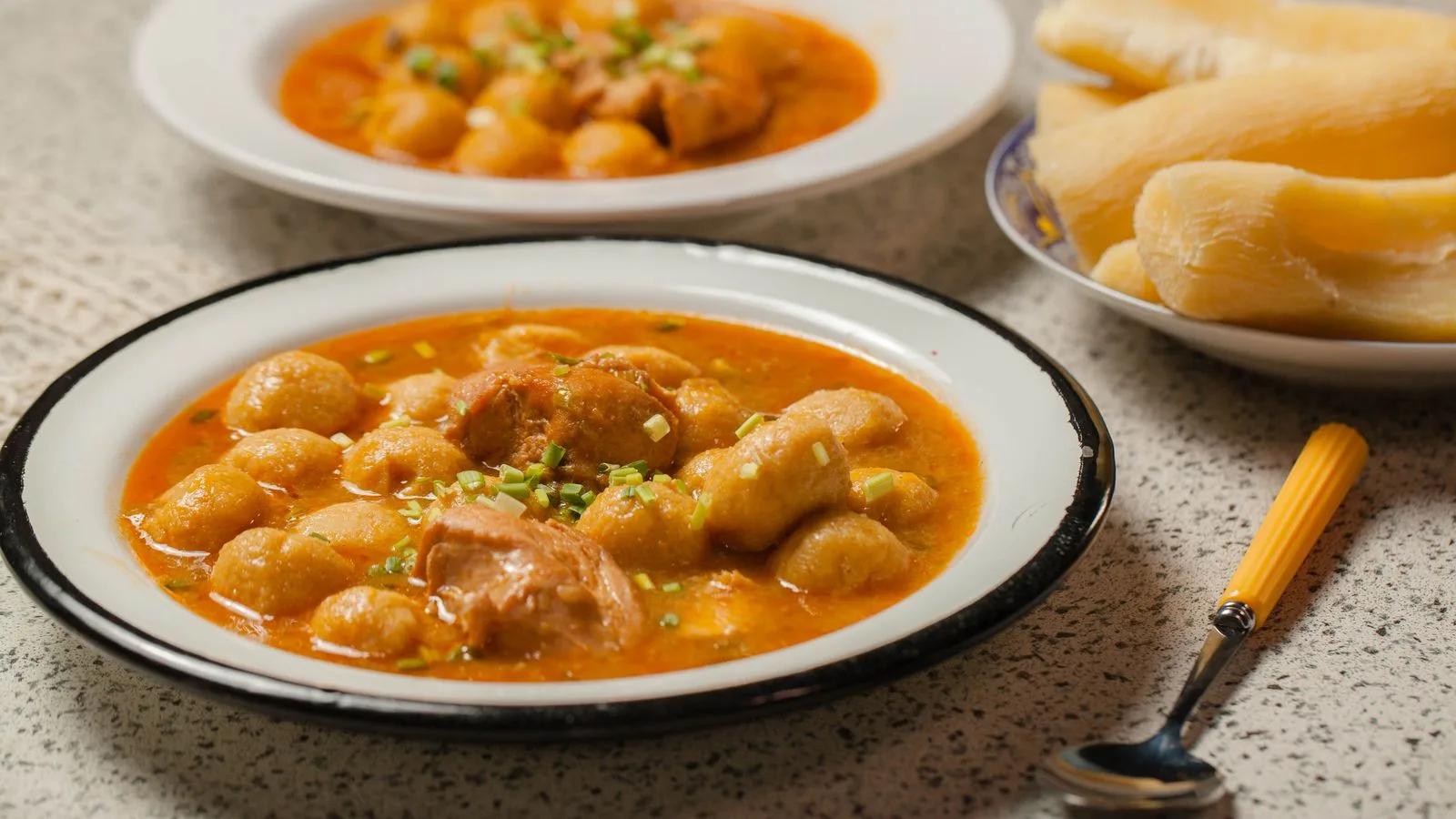 Delicious homemade Paraguayan chicken soup with cassava dumplings served on a rustic table.