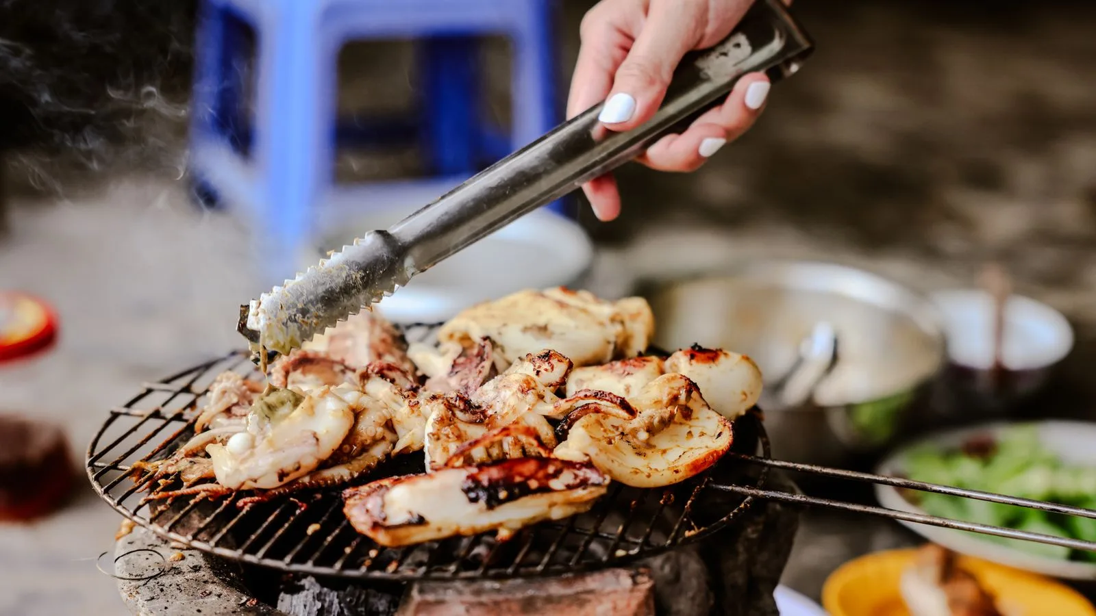 Delicious grilled chicken and seafood prepared on outdoor barbecue. Perfect outdoor meal.
