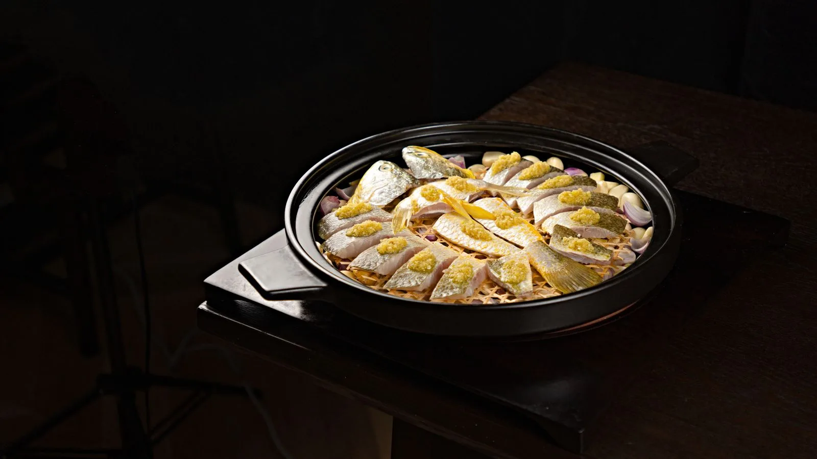 Delicious fish dish garnished with lemon and garlic, ready for a gourmet meal.